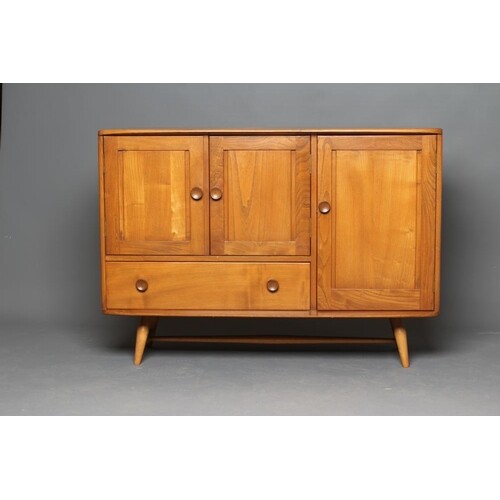 AN ERCOL GOLDEN ELM SIDEBOARD, 1960's, the rounded oblong to...
