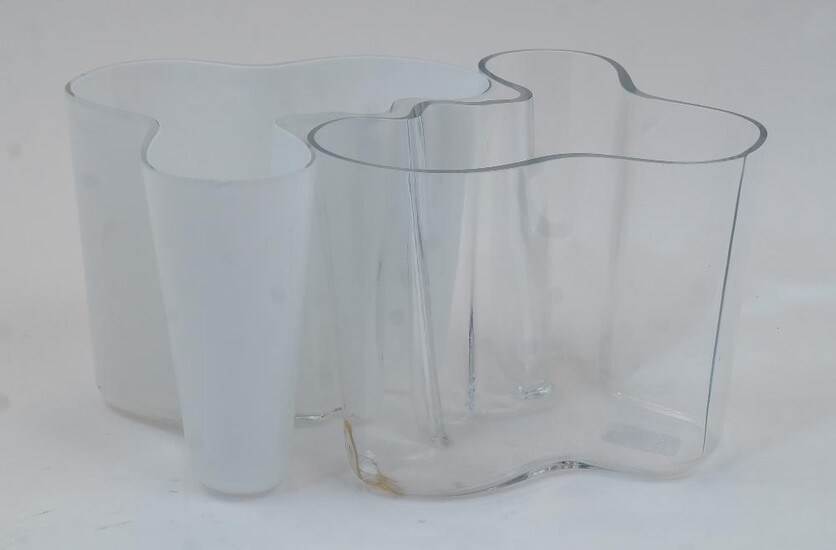 Alvar Aalto, Finnish, 1898-1976, a Savoy vase, clear glass, bearing etched signature to the underside, 15.8cm high, together with another similar vase in white opaque glass, unsigned, 15.8cm high (2)