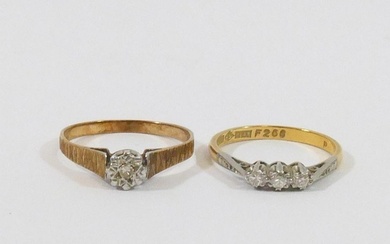An 18 carat gold diamond three stone ring, the round brillia...