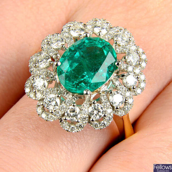 An 18ct gold emerald and brilliant-cut diamond floral cluster ring.