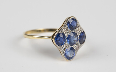 An 18ct gold, sapphire and diamond lozenge shaped cluster ring, mounted with five circular and oval