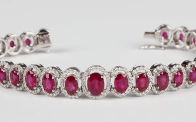 An 18ct white gold, treated ruby and diamond cluster bracelet, mounted with a graduated row of oval