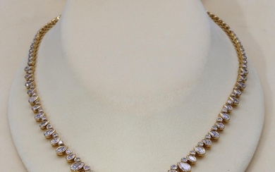 An 18ct yellow gold diamond necklace set with centre pear sh...