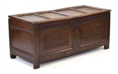 An 18th century oak coffer of long proportions, the four-panelled...