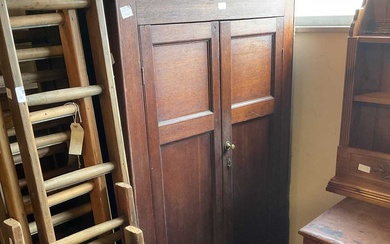An 18th century oak tack cupboard with moulded cornice above...