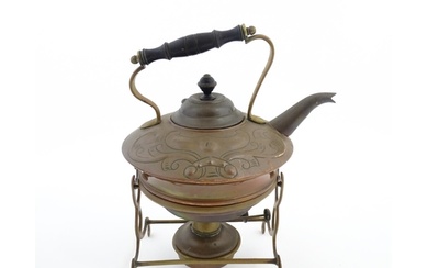 An Art Nouveau copper and brass spirit kettle and burner on ...