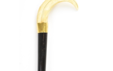 An Edwardian ebonised walking stick, with a warthog tusk han...
