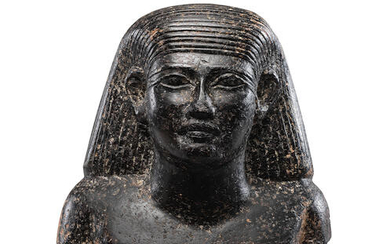 An Egyptian granite bust of an official
