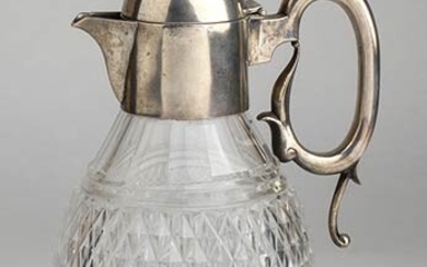 An English cut glass pitcher with sterling silver top -...