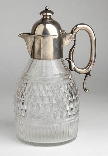 An English cut glass pitcher with sterling silver top -...