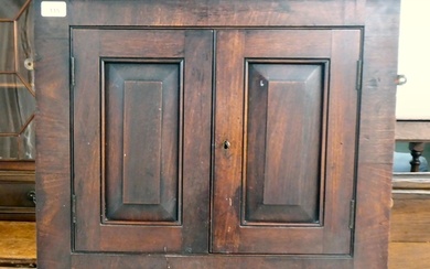 An early 19thC Georgian mahogany hanging corner cupboard wit...