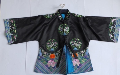 An early 20thC black silk robe, embroidered with brightly...