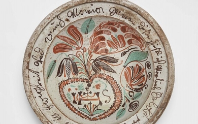 An earthenware dish with a banderole