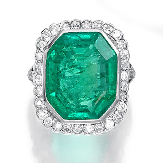 An emerald, diamond, and platinum ring designed as an...