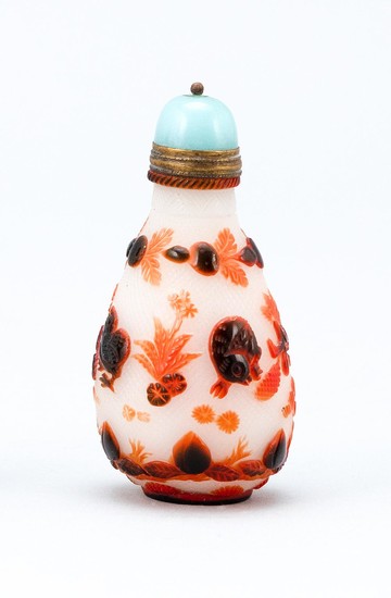CHINESE OVERLAY GLASS SNUFF BOTTLE In teardrop form, with red and orange bird and leaf decoration on a stippled ground. Height 2.25"...