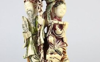 Four figures under a tree, group of figures made of ivory, China c. 1930, carved in one piece in openwork design and partially painted red, green and black, flute player, scholar with scrolls, lady with fan and gentleman with palm leaf, middle piece...