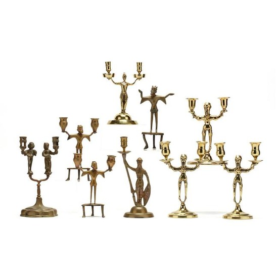 Nine Antique Figural Brass Candlesticks
