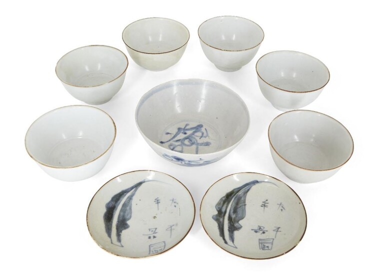 Nine pieces of Chinese porcelain excavated from the Vung Tau Cargo, circa 1690, comprising six white-glazed bowls with brown-dressed rims, a bowl decorated in underglaze blue with a dragon chasing a flaming pearl, and two footed dishes decorated...