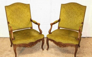 Pair of antique highly carved French style arm chairs