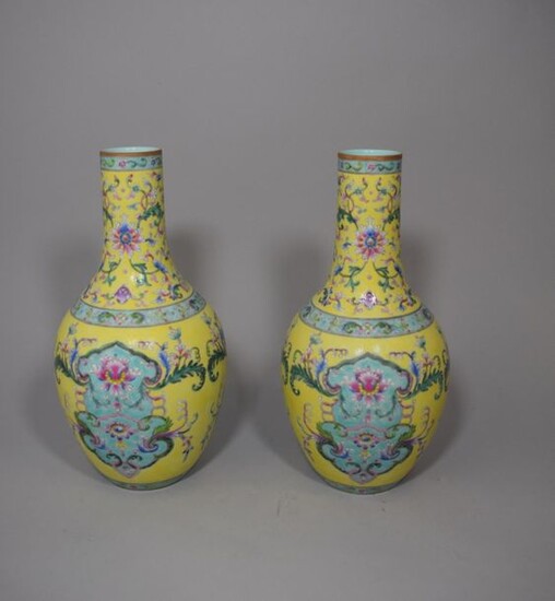 Pair of long neck porcelain vases with polychrome floral decoration on a yellow and turquoise background. Apocryphal Jiaqing mark.