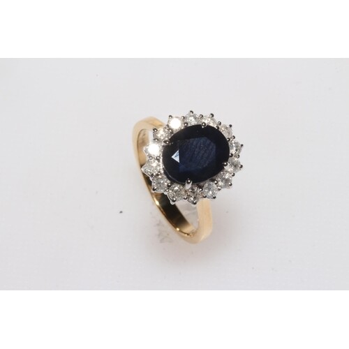 Sapphire and diamond 18 carat gold cluster ring, having oval...