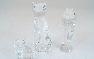 Three Steuben glass cats, 20th century, comprising two modelled seated and one on two legs, the tallest 22.5cm high (3)
