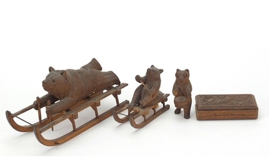 Three carved Black Forest bears and a matchbox including two...