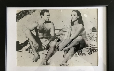 Unknown photographer: B/W photograph of the English actor Sir Sean Connery (b. 1930) in his role as James Bond flanked by Claudine Auger.