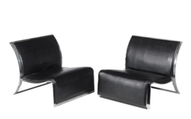A pair of low lounge chairs