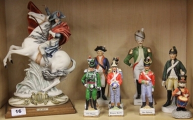 A resin figure by B.Merli, H. 31cm together with a group of porcelain soldier figures.