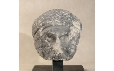 A sculpted limestone fragmentary visage of a knight