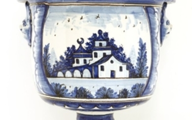 A tin-glazed blue and white pottery urn