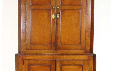 A 18th century oak floor standing corner cupboard, with blind...
