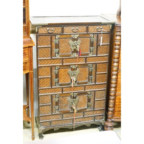 A 20th century Chinese stained wood and rattan side cabinet,...