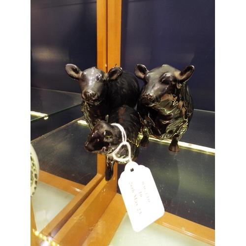 A Beswick Aberdeen Angus bull, cow and calf