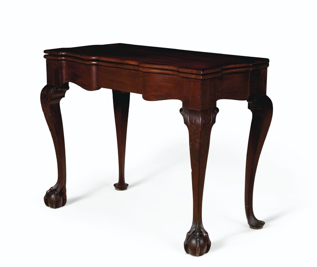 A CHIPPENDALE CARVED MAHOGANY SCALLOP-TOP CARD TABLE