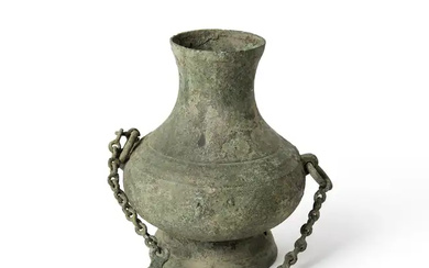 A Chinese archaic bronze vessel, hu, Han dynasty, the compressed body raised...