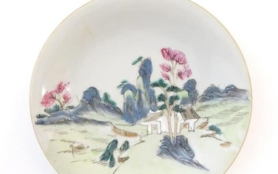 A Chinese plate decorated with a landscape scene with a