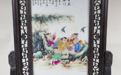 A Chinese polychrome and hardwood table screen depicting children...