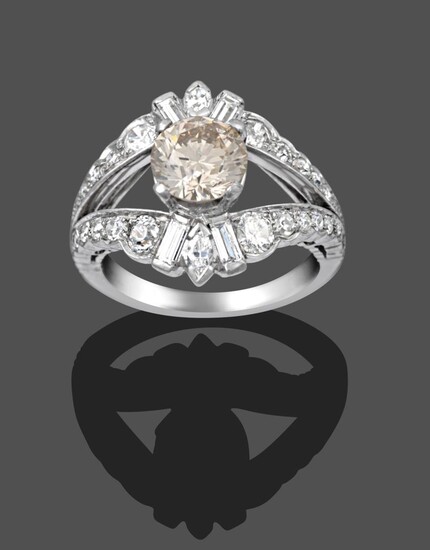 A Diamond Cluster Ring, the central fancy light brown round brilliant cut diamond in a white...