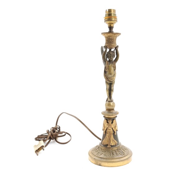 A French 19th century gilt and patinated bronze table lamp, stem in shape of a winged youngster. H. 35 cm.