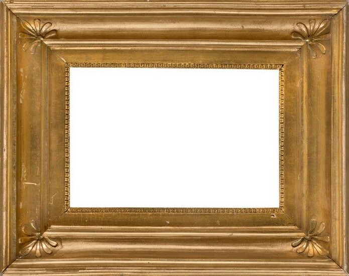 A French Gilded Empire Style Frame, early-mid 19th century, with rais-de-coeur sight, the scotia with palmette corners and top torus, 20.5 x 32 cm. (sight).