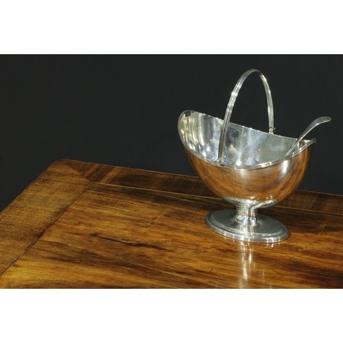 A George III silver boat shaped pedestal sugar basket, reede...
