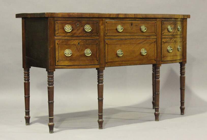 A George IV mahogany bowfront sideboard with ebony stringing, fitted with two short drawers flanked