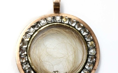 A Georgian gold and paste set circular glazed locket