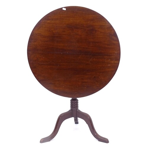 A Georgian mahogany circular tilt-top table, on tripod base,...