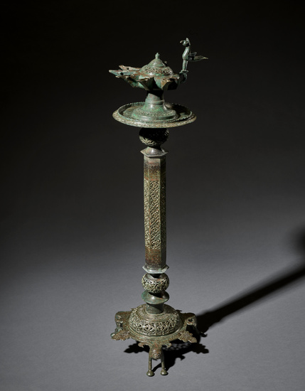 A LARGE AND IMPRESSIVE KHORASSAN BRONZE LAMPSTAND WITH OIL LAMP...