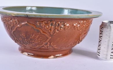 A LARGE CHINESE REPUBLICAN PERIOD BROWN GLAZED POTTERY BOWL decorated with foliage. 34 cm x 14 cm.