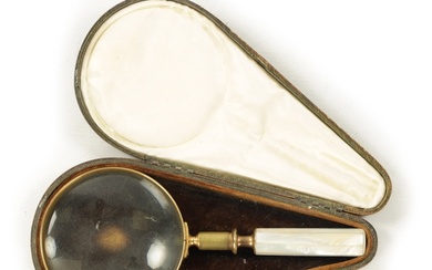 A LATE 19TH CENTURY CASED MAGNIFYING GLASS with a tooled Mor...