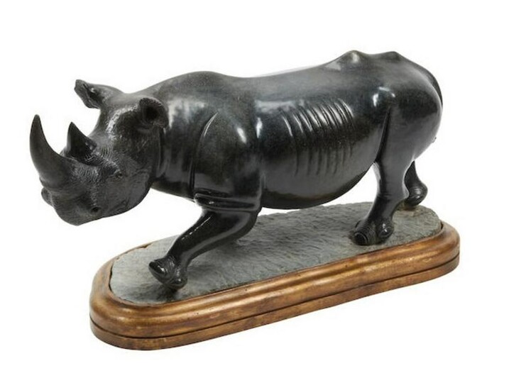 A Large Carved Black Marble Figure of A Rhinoceros on